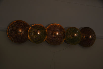 Metal round red and green wall art with tealight